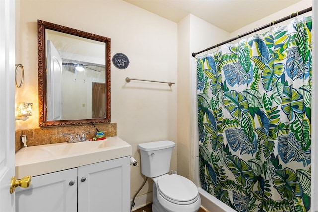 full bath featuring toilet, curtained shower, and vanity