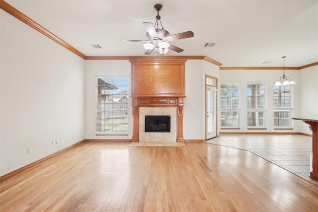 unfurnished living room featuring light wood finished floors, plenty of natural light, and visible vents