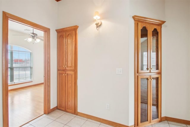 interior space featuring light tile patterned flooring and baseboards