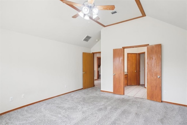 unfurnished bedroom featuring high vaulted ceiling, light colored carpet, visible vents, and baseboards