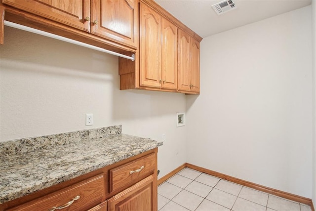 washroom with light tile patterned floors, hookup for a washing machine, cabinet space, visible vents, and baseboards