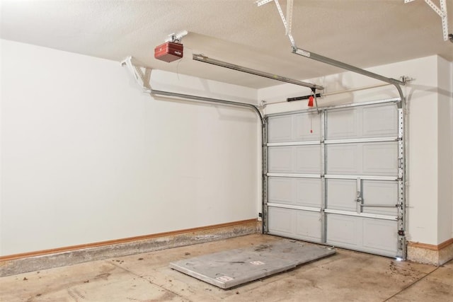 garage featuring baseboards and a garage door opener