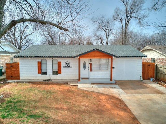 single story home featuring brick siding, a front lawn, and fence