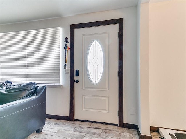 foyer featuring a wealth of natural light, baseboards, and wood tiled floor