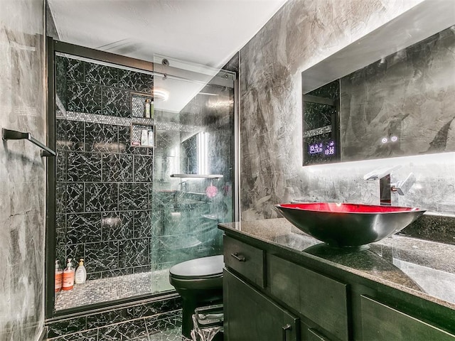 bathroom featuring toilet, marble finish floor, a shower stall, and vanity