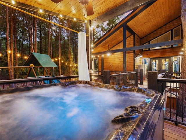 exterior space with a jacuzzi, wood ceiling, and lofted ceiling