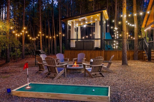 patio at twilight featuring an outdoor fire pit