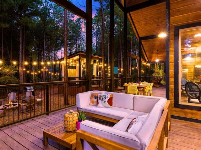 wooden terrace with outdoor dining space and outdoor lounge area