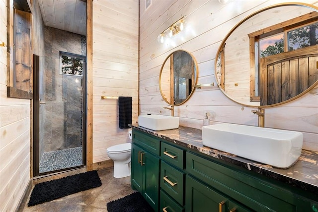 full bath with double vanity, a stall shower, wood walls, and a sink