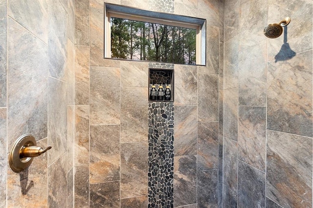 interior details with a tile shower