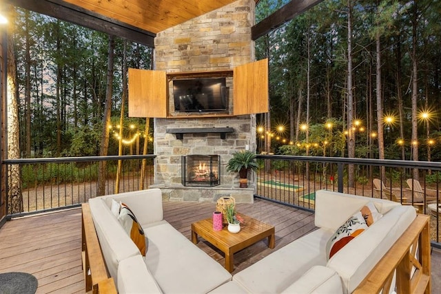 deck featuring an outdoor living space with a fireplace