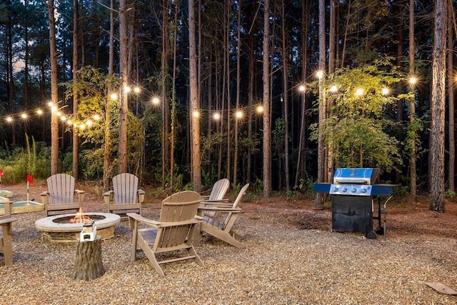 view of yard with a fire pit