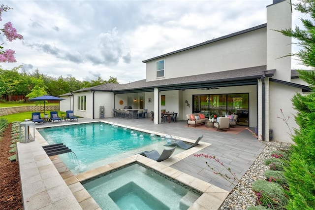 outdoor pool featuring a patio, outdoor dry bar, an in ground hot tub, fence, and an outdoor living space