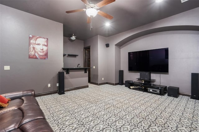 home theater featuring carpet floors, a ceiling fan, and baseboards