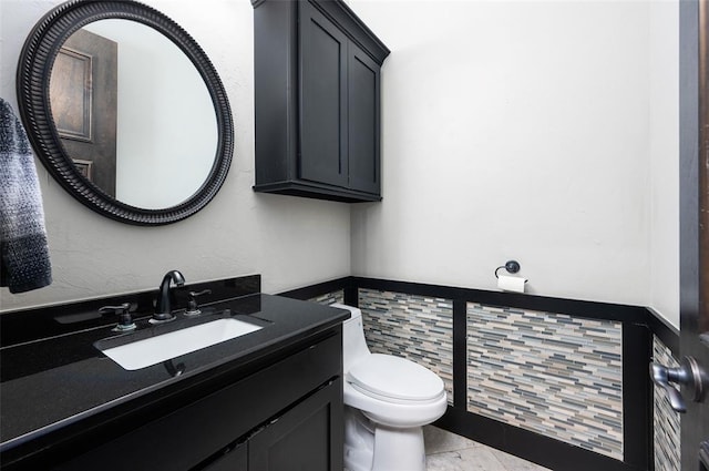 bathroom featuring toilet and vanity