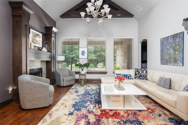 living room featuring visible vents, arched walkways, dark wood-type flooring, a fireplace, and high vaulted ceiling