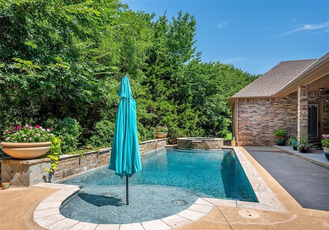 view of pool featuring a pool with connected hot tub and a patio area