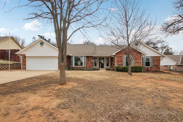 single story home with a garage, concrete driveway, and brick siding