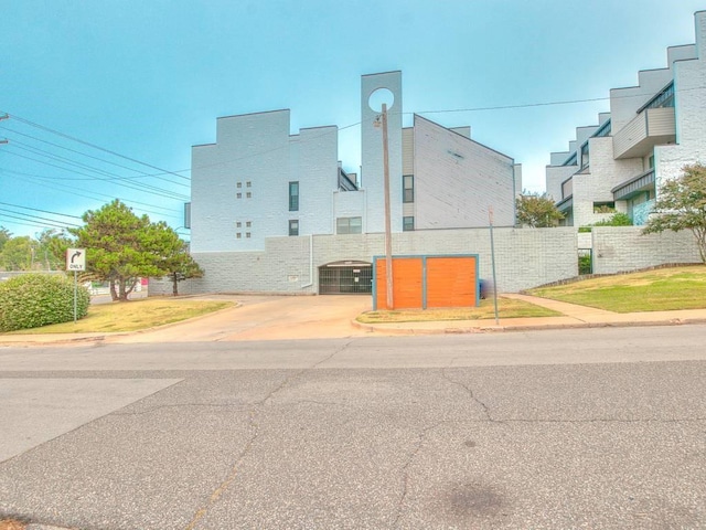 view of building exterior featuring fence and central AC