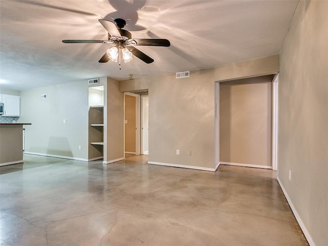 spare room with visible vents, finished concrete flooring, and baseboards