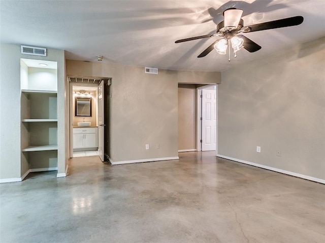 unfurnished room with concrete flooring, visible vents, and baseboards