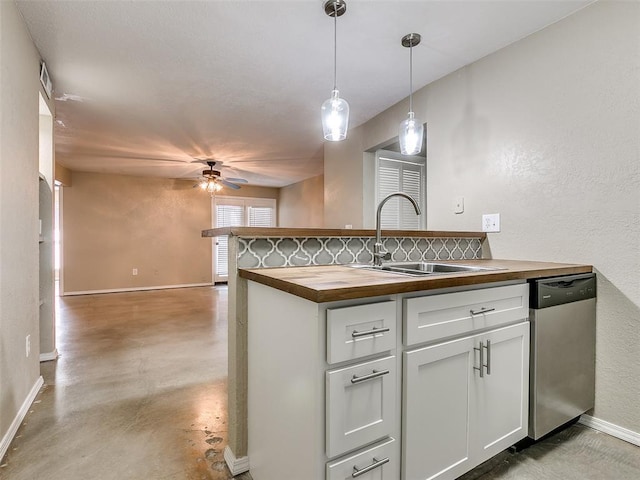 kitchen with butcher block counters, a sink, stainless steel dishwasher, and a ceiling fan