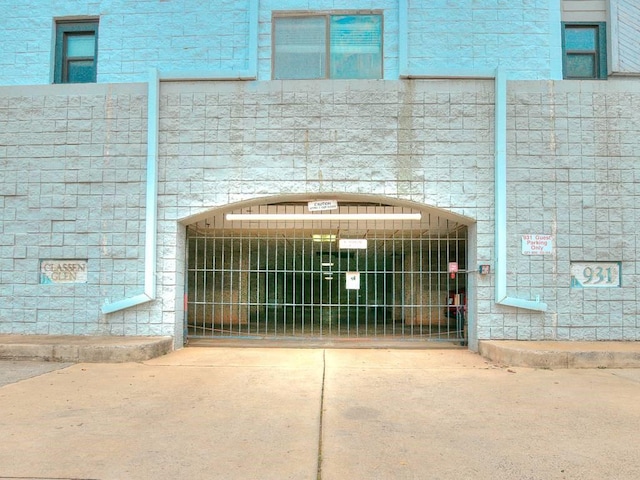 exterior space with driveway and a gate