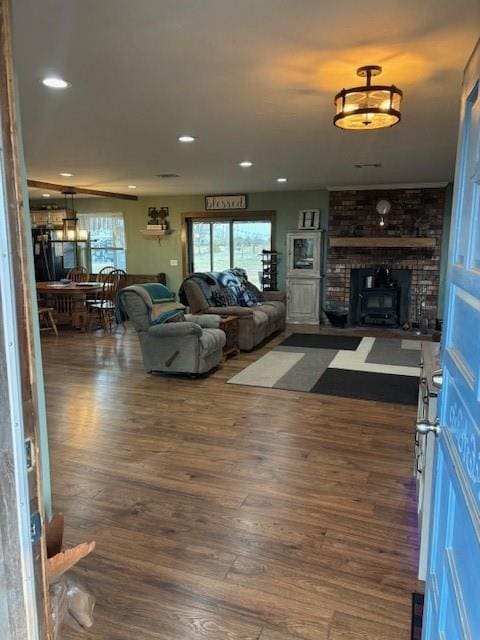 living room featuring a fireplace, plenty of natural light, dark wood-style floors, and recessed lighting