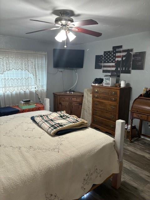 bedroom with a ceiling fan and wood finished floors