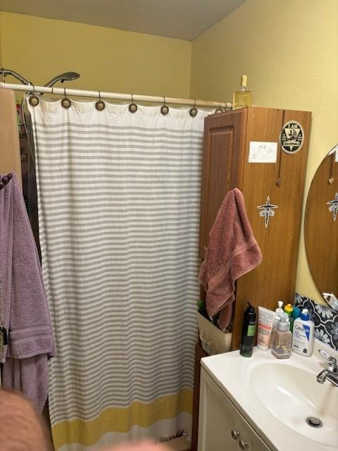 bathroom featuring vanity and shower / bath combo with shower curtain