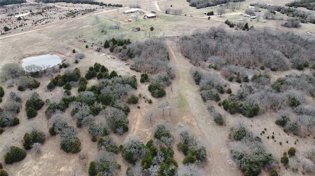 birds eye view of property featuring a rural view and a desert view