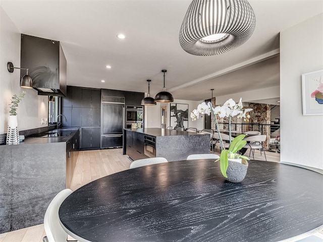 dining room with recessed lighting, light wood-style floors, and a chandelier