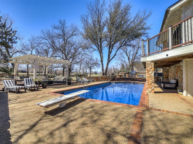 view of swimming pool with a diving board, a patio area, a fenced in pool, and a pergola