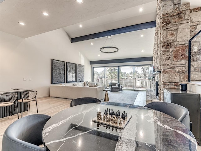 dining room with recessed lighting, lofted ceiling with beams, baseboards, and wood finished floors