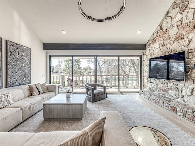 living area featuring high vaulted ceiling and wood finished floors