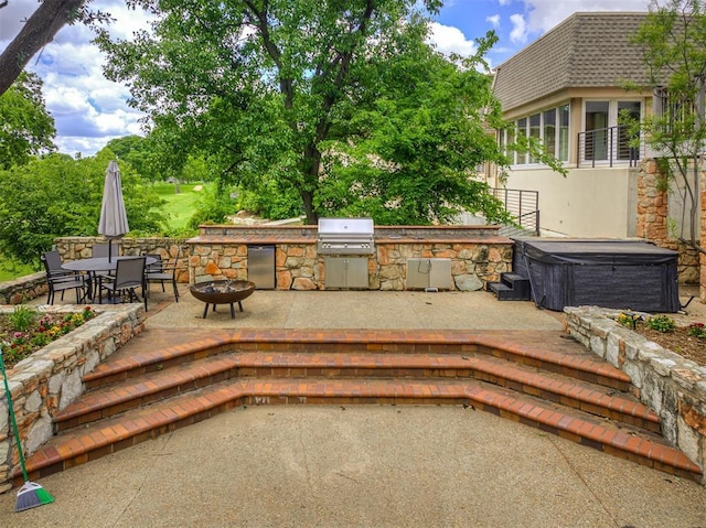 3108 Brush Creek Rd, Oklahoma City, OK 73120 - view of patio featuring a hot tub, a grill, exterior kitchen, an outdoor fire pit, and outdoor dining area