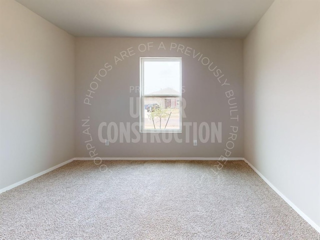 carpeted spare room with baseboards