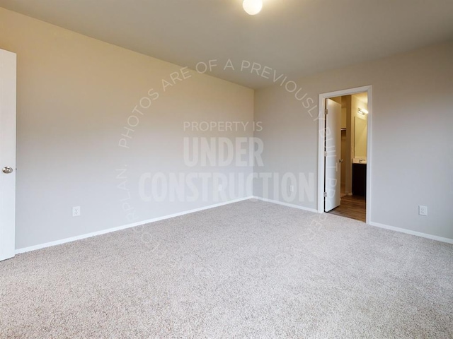 unfurnished room with carpet floors and baseboards