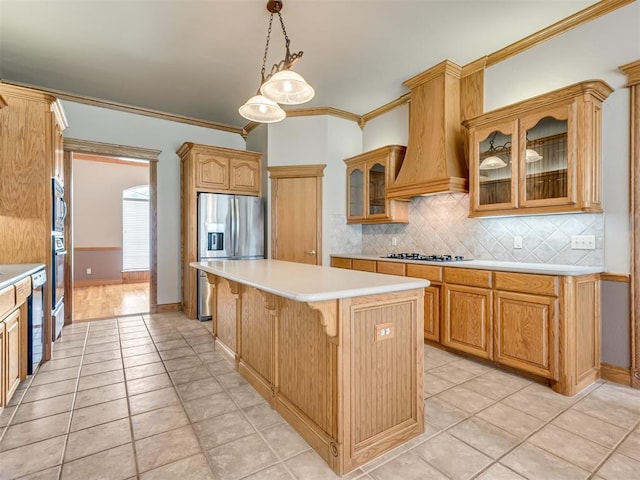 kitchen featuring ornamental molding, custom range hood, stainless steel appliances, a breakfast bar area, and light countertops