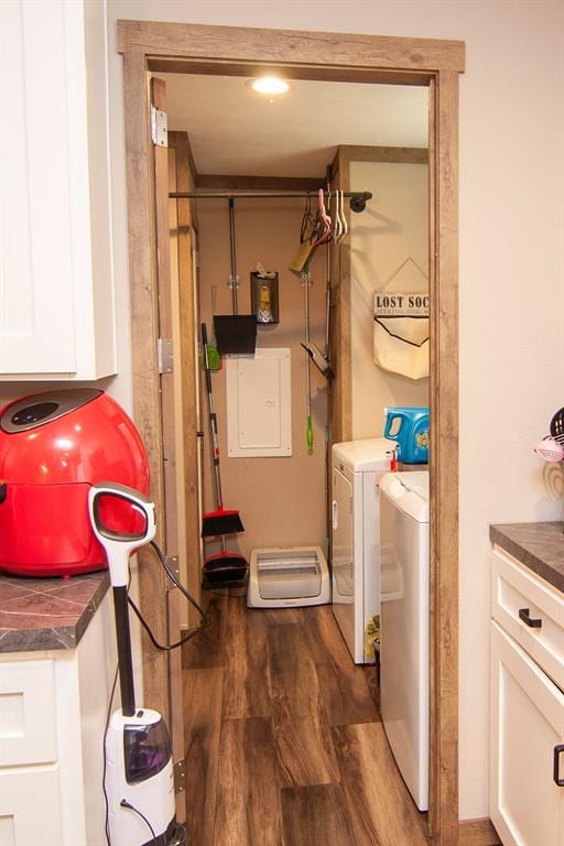 washroom featuring laundry area, washer and clothes dryer, and wood finished floors