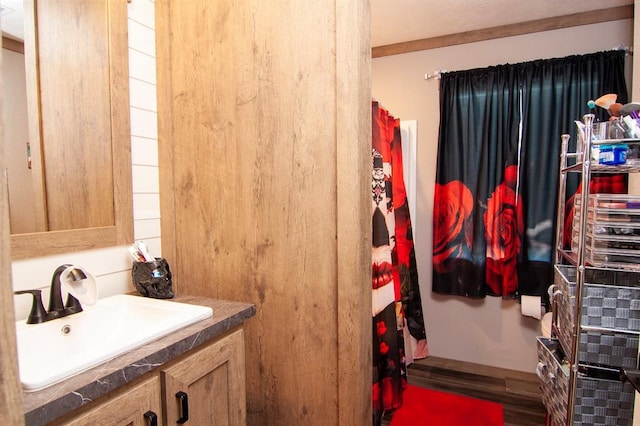 bathroom with wood finished floors and vanity