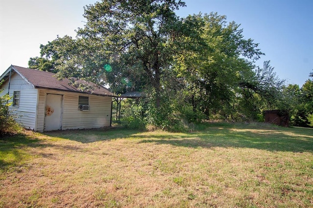 view of yard featuring cooling unit and an outbuilding