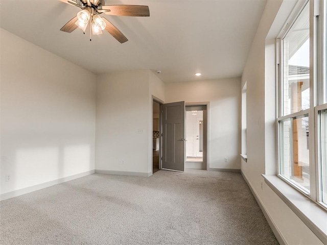 carpeted spare room featuring ceiling fan, recessed lighting, plenty of natural light, and baseboards