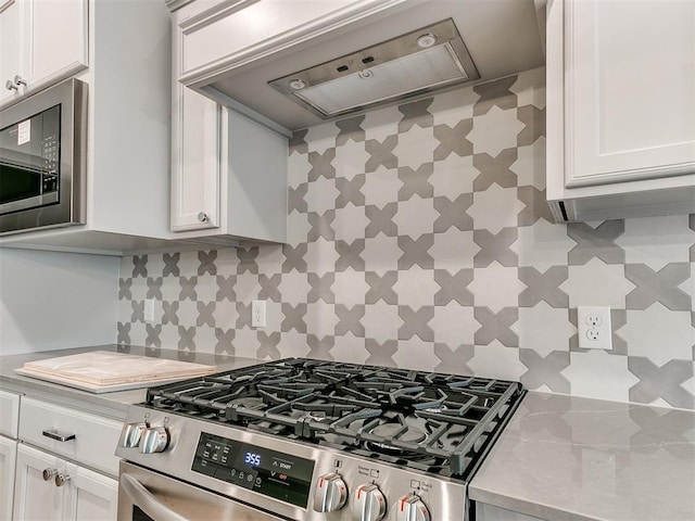 kitchen featuring white cabinetry, light countertops, built in microwave, stainless steel gas stove, and custom range hood