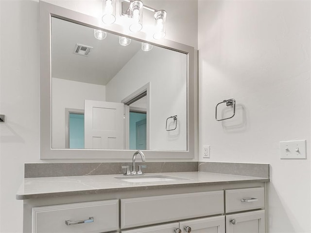 bathroom with visible vents and vanity