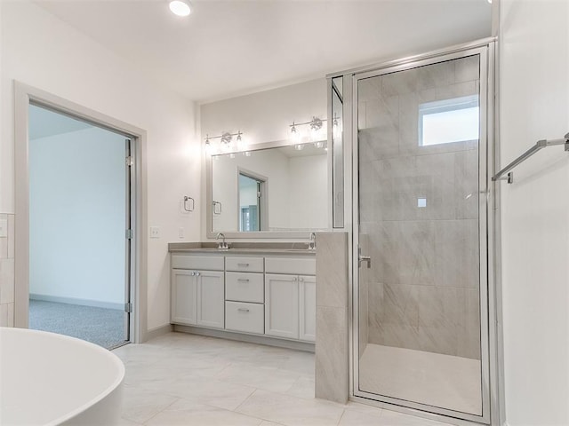 full bathroom featuring a stall shower, a soaking tub, a sink, and double vanity