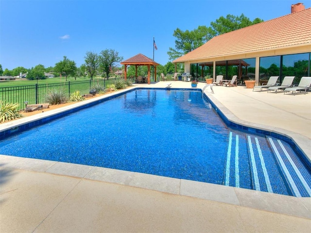 view of swimming pool featuring a gazebo, a patio area, fence, and a fenced in pool