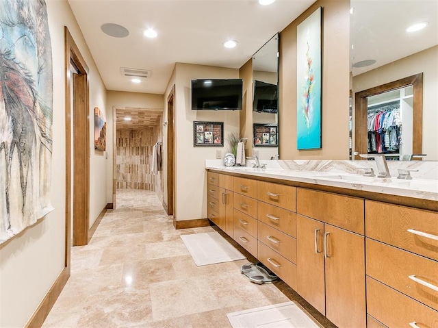 full bathroom with double vanity, baseboards, visible vents, a spacious closet, and recessed lighting