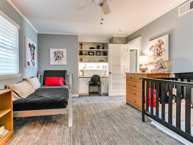 bedroom featuring carpet, crown molding, visible vents, a ceiling fan, and built in study area