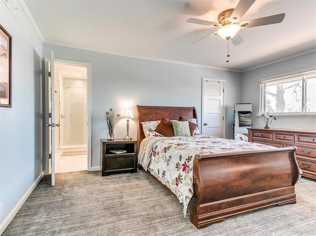 bedroom featuring carpet, ornamental molding, ceiling fan, ensuite bath, and baseboards